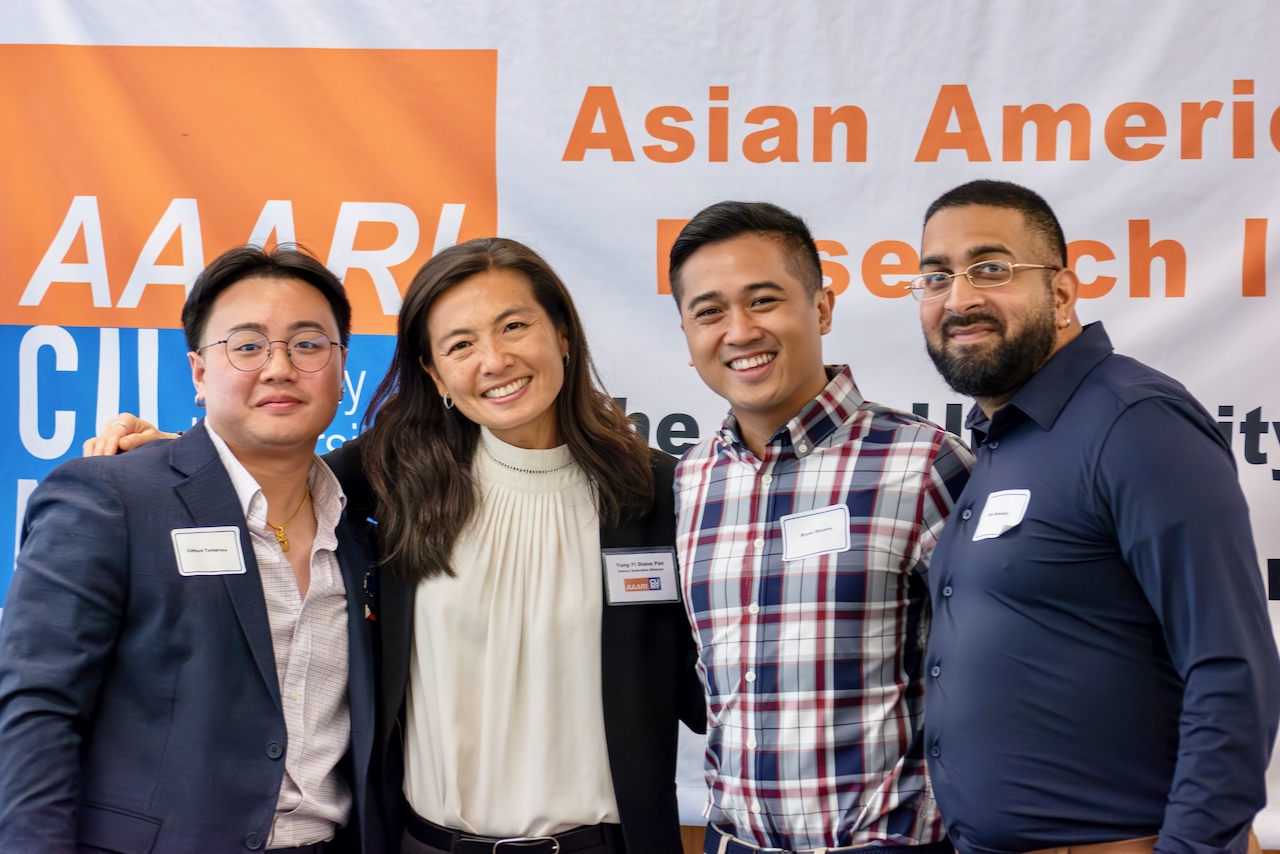 Presenters at the AAARI Symposium smile with the conference organizer.